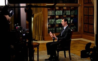President Bashar Assad gestures as he speaks during an interview with Lebanon’s Al-Mayadeen TV, at the presidential palace in Damascus, Syria, Monday, Oct. 21, 2013 (photo credit: AP/SANA)