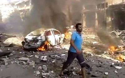 The aftermath of a car bomb attack on a market in the Syrian town of Darkoush, in Idlib province, last month (photo credit: AP/Shaam News Network)