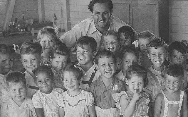 Long-time school master Mr. Scheer with school children (photo credit: courtesy)