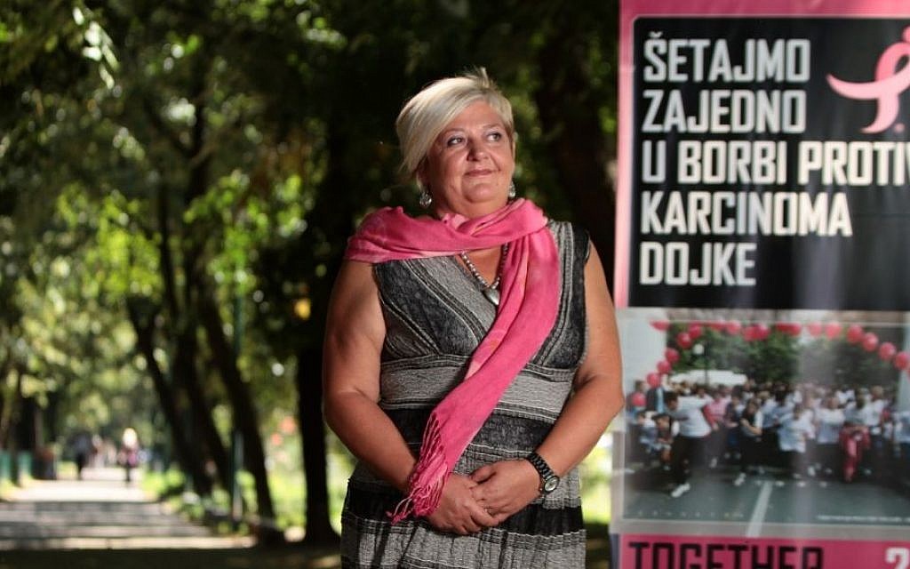 Nela Hasic, pictured here with a Race for the Cure poster, returned from Israel to her native Sarajevo and is leading the fight for breast cancer awareness there. (photo credit: Courtesy of JDC) Nela Hasic, pictured here with a Race for the Cure poster, returned from Israel to her native Sarajevo and is leading the fight for breast cancer awareness there. (photo credit: Courtesy of JDC)