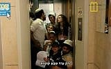 Illustrative: A humorous Israeli promotional video featuring a Shabbat elevator. The caption reads, 'Only seven more floors to go.' (photo credit: YouTube screenshot)