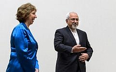 EU High Representative for Foreign Affairs Catherine Ashton, left, walks next to Iranian Foreign Minister Mohammad Javad Zarif during a photo opportunity prior to the start of two days of closed-door nuclear talks on Tuesday, October 15, 2013, at the United Nations offices in Geneva. (photo credit: AP/Fabrice Coffrini, Pool)
