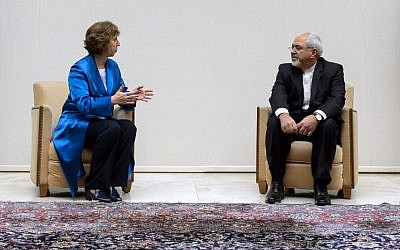 EU High Representative for Foreign Affairs Catherine Ashton, left, talks to Iranian Foreign Minister Mohammad Javad Zarif, right, during a photo opportunity prior to the start of two days of closed-door nuclear talks on Tuesday, October 15, 2013. (photo credit: AP/Fabrice Coffrini, pool)
