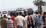 Tunisian police officers secure the place where a suicide bomber blew himself up near a seaside hotel in Sousse,Tunisia, Wednesday, Oct. 30, 2013 (photo credit: AP/Raghda Jammali)