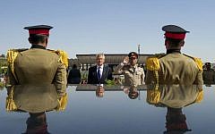 US Secretary of Defense Chuck Hagel, second from left, stands with an Egyptian army official before laying a wreath at the tomb of late president Anwar Sadat in Cairo, April 24, 2013 (photo credit: AP/Jim Watson/File)