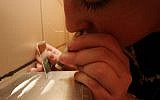 A woman snorts coke in the toilet of a Jerusalem bar. (illustrative photo credit: Michal Fattal/Flash90)