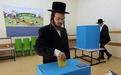 An ultra-Orthodox man votes at a polling station during Israel’s municipal elections, October 22, 2013. (photo credit: Yaakov Naumi/Flash90)