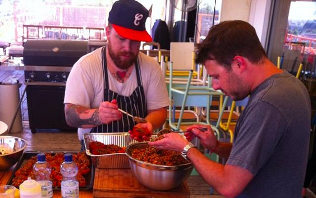 Chefs Jonathon Sawyer and Adam Sobel stuffing vegetables for dinner (Courtesy Inbal Baum)