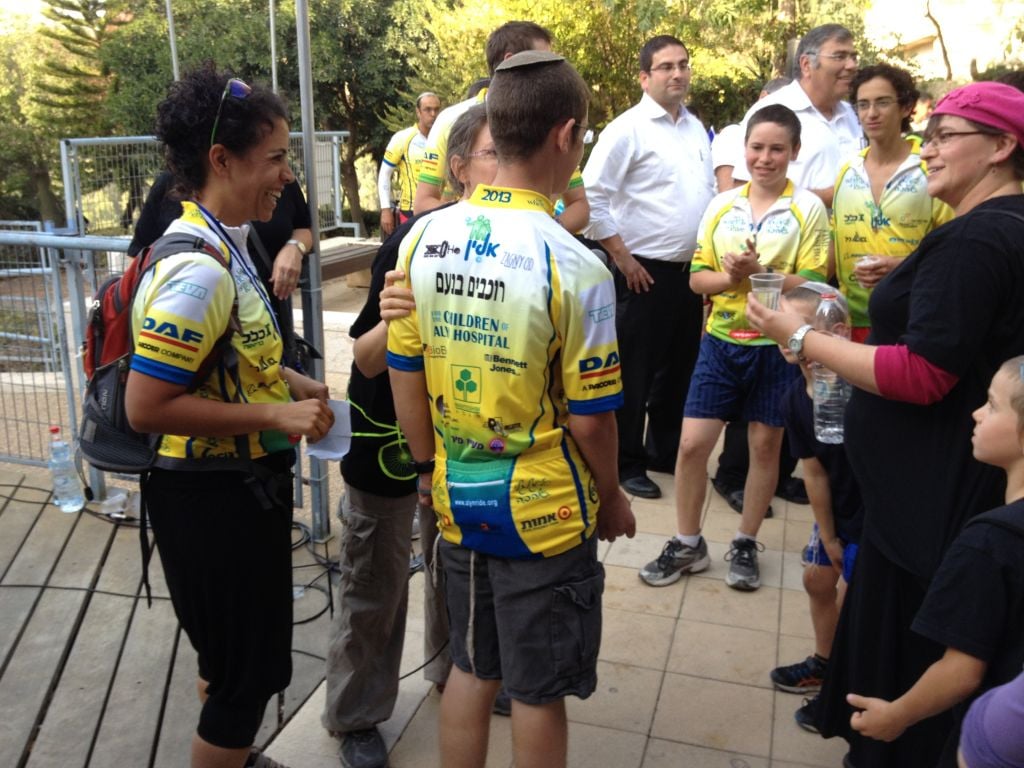 Ruth Vitztum congratulating one of her riders (photo credit: Jessica Steinberg/Times of Israel)