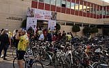 Cyclists riding in, getting medals, snacks and drinks before the end-of-ride celebration at Alyn Hospital.(photo credit: Jessica Steinberg/Times of Israel)