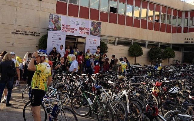 Cyclists riding in, getting medals, snacks and drinks before the end-of-ride celebration at Alyn Hospital.(photo credit: Jessica Steinberg/Times of Israel) Cyclists riding in, getting medals, snacks and drinks before the end-of-ride celebration at Alyn Hospital.(photo credit: Jessica Steinberg/Times of Israel)