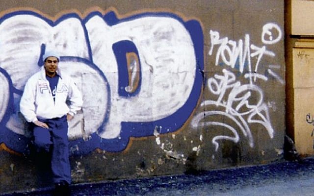 Arye Sharuz Shalicar, a well known graffiti artist, in front of some of his old work (Photo credit: courtesy Arye Shalicar)