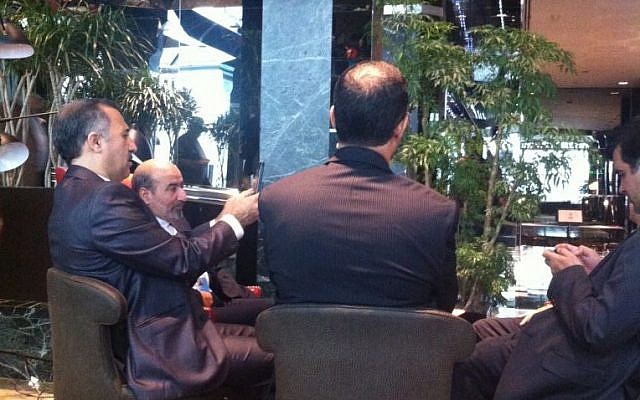 Iranian delegates in the lobby of the UN One hotel, listening to Hassan Rouahani's press conference (photo credit: Tal Shalev)