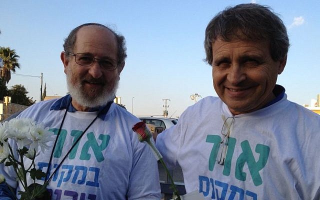 Gadi Gvaryahu (right) and Rabbi Yehiel Grenimann of Rabbis for Human Rights stand outside the Rami Levi supermarket as part of the Tag Meir activities (photo credit: Elhanan Miller/Times of Israel)