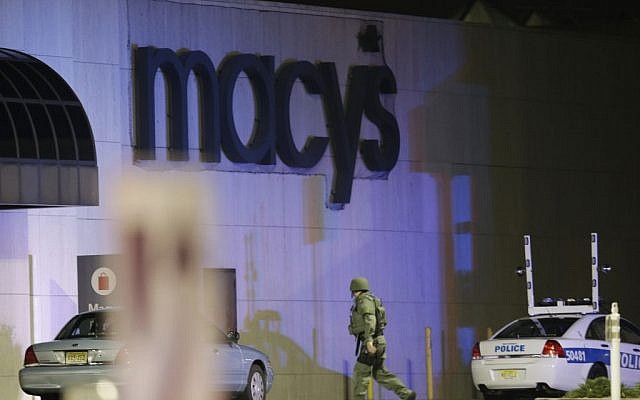 An official wearing tactical gear walks outside of Garden State Plaza Mall following reports of a shooter, on Monday, November 4, 2013, in Paramus, N.J. (photo credit: AP/Julio Cortez) An official wearing tactical gear walks outside of Garden State Plaza Mall following reports of a shooter, on Monday, November 4, 2013, in Paramus, N.J. (photo credit: AP/Julio Cortez)