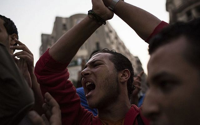 Egyptian youths chant slogans during a demonstration in support of Egyptian political satirist Bassem Youssef after a local TV station stops the airing of his show in Cairo, Egypt, Saturday Nov. 2, 2013 (photo credit: AP/Manu Brabo) Egyptian youths chant slogans during a demonstration in support of Egyptian political satirist Bassem Youssef after a local TV station stops the airing of his show in Cairo, Egypt, Saturday Nov. 2, 2013 (photo credit: AP/Manu Brabo)