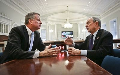 Then- New York City Mayor-elect Bill de Blasio, left, joins Mayor Michael Bloomberg for a meeting in the 'Bull Pen,' the mayor's main City Hall office, on Wednesday, Nov. 6, 2013, in New York. (photo credit: AP Photo/Bebeto Matthews)