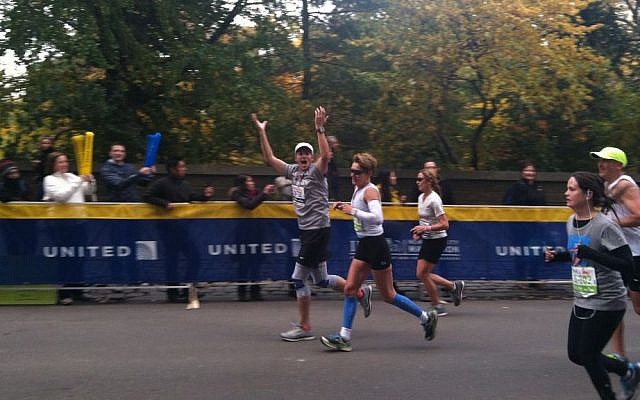 Aharon Karov, who was severely injured in Operation Cast Lead, completes the New York City Martahon, and smiles at his supporters as he does his thing. (photo credit: Talia Langer)