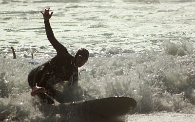 Rabbi Eliyahu Fink tries to catch a wave during the filming of an episode of 'Church Rescue'. (photo credit: Courtesy of T Group Productions)