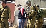 Illustrative photo of Israeli soldiers blindfolding and detaining Palestinians. (Najeh Hashlamoun/Flash90)