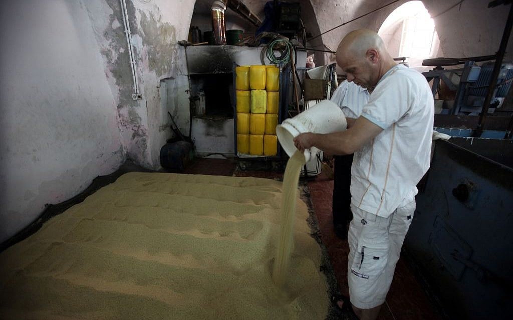 Working through the sesame seeds at the Jebrini tahini factory in the Old City of Jerusalem (photo credit: Yossi Zamir/Flash 90) Working through the sesame seeds at the Jebrini tahini factory in the Old City of Jerusalem (photo credit: Yossi Zamir/Flash 90)