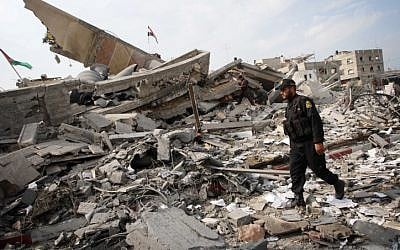 A Palestinian police officer walking amid the destroyed buildings in Gaza on the day after the end of Operation Pillar of Defense. (photo credit: Abed Rahim Khatib/Flash90) A Palestinian police officer walking amid the destroyed buildings in Gaza on the day after the end of Operation Pillar of Defense. (photo credit: Abed Rahim Khatib/Flash90)