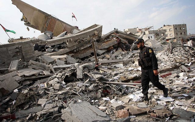 A Palestinian police officer walking amid the destroyed buildings in Gaza on the day after the end of Operation Pillar of Defense. (photo credit: Abed Rahim Khatib/Flash90) A Palestinian police officer walking amid the destroyed buildings in Gaza on the day after the end of Operation Pillar of Defense. (photo credit: Abed Rahim Khatib/Flash90)