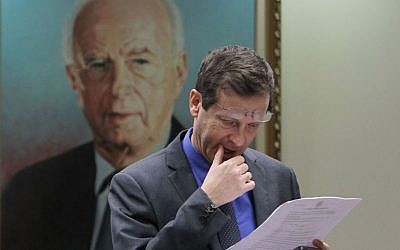 Labor party chair Isaac Herzog seen in front of a painting of late Israeli prime minister Yitzhak Rabin prior to a party meeting in the Knesset, March 2013. (Photo by Miriam Alster/FLASH90)