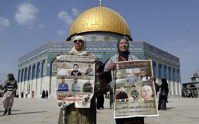 Palestinian women hold pictures of sick Palestinian prisoners held in Israeli jails outside the Dome of the Rock during a demonstration in solidarity with Palestinian prisoners held in Israeli jails. November 1, 2013 (photo credit: Sliman Khadr/Flash90) Palestinian women hold pictures of sick Palestinian prisoners held in Israeli jails outside the Dome of the Rock during a demonstration in solidarity with Palestinian prisoners held in Israeli jails. November 1, 2013 (photo credit: Sliman Khadr/Flash90)