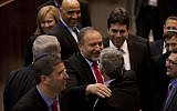 Smiles all around as Avigdor Liberman is congratulated by Finance Minster Yair Lapid on his reappointment as foreign minister (photo credit:Flash90)