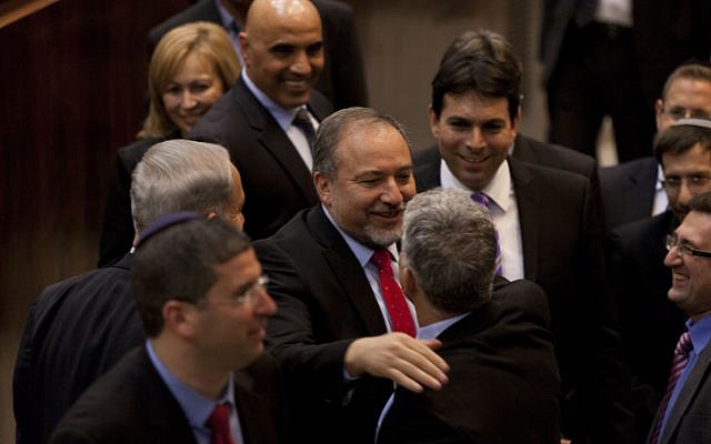 Smiles all around as Avigdor Liberman is congratulated by Finance Minster Yair Lapid on his reappointment as foreign minister (photo credit:Flash90) Smiles all around as Avigdor Liberman is congratulated by Finance Minster Yair Lapid on his reappointment as foreign minister (photo credit:Flash90)