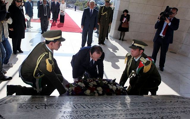 French President Francois Hollande lays a wreath at the grave of late Palestinian Authority president Yasser Arafat, at the Muqata compound in the West Bank city of Ramallah, Monday November 18, 2013 (photo credit: Issam Rimawi/Flash90)