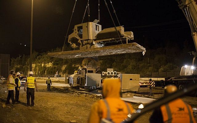 Workers moving the armored truck late Tuesday. (photo credit: Yonatan Sindel/Flash90) Workers moving the armored truck late Tuesday. (photo credit: Yonatan Sindel/Flash90)
