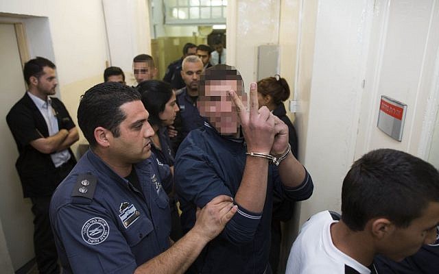 Two of the suspects alleged to have thrown stones at the car that left 2-year-old Avigail Ben Zion moderately wounded are escorted by police in the Magistrate's Court in Jerusalem, November 29, 2013. (Photo credit: Yonatan Sindel/Flash90) Two of the suspects alleged to have thrown stones at the car that left 2-year-old Avigail Ben Zion moderately wounded are escorted by police in the Magistrate's Court in Jerusalem, November 29, 2013. (Photo credit: Yonatan Sindel/Flash90)