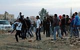 Police and protesters clash at a rally where around 1,200 demonstrators gathered in the southern Israeli town of Hura during a protest against the government's plan to resettle some 30,000 Bedouin residents of the Negev desert. November 30, 2013. (Photo credit: Flash90)