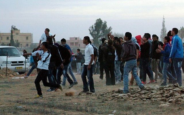 Police and protesters clash at a rally where around 1,200 demonstrators gathered in the southern Israeli town of Hura during a protest against the government's plan to resettle some 30,000 Bedouin residents of the Negev desert. November 30, 2013. (Photo credit: Flash90) Police and protesters clash at a rally where around 1,200 demonstrators gathered in the southern Israeli town of Hura during a protest against the government's plan to resettle some 30,000 Bedouin residents of the Negev desert. November 30, 2013. (Photo credit: Flash90)