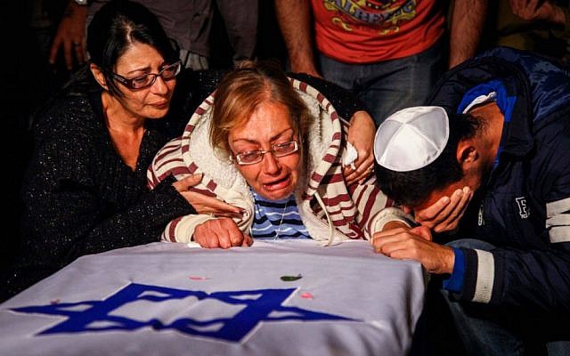 The family of Israeli soldier Eden Atias mourns over his coffin during a funeral in Nazareth-Illit , northern Israel, on Wednesday (photo credit: Avishag Shaar Yashuv/Flash90) The family of Israeli soldier Eden Atias mourns over his coffin during a funeral in Nazareth-Illit , northern Israel, on Wednesday (photo credit: Avishag Shaar Yashuv/Flash90)