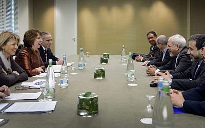 EU foreign policy chief Catherine Ashton, second left, and Iranian Foreign Minister Mohammad Javad Zarif, third right, are pictured during talks over Iran's nuclear program in Geneva, Switzerland, on Friday. (photo credit: AP/Fabrice Coffrini)