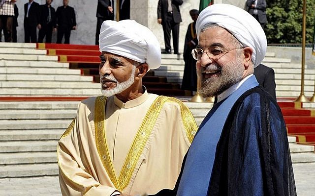 Iranian President Hasan Rouhani, right, shakes hands with Omani Sultan Qaboos during an official arrival ceremony, in Tehran, Iran, Aug. 25, 2013. (photo credit: AP/Iranian Presidency Office, Hojjat Sepahvand)