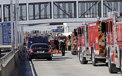Police stand outside Los Angeles International Airport on Friday, Nov. 1, 2013. Shots were fired Friday at Los Angeles International Airport, prompting authorities to evacuate a terminal and stop flights headed for the city from taking off from other airports. (photo credit: AP/Reed Saxon)
