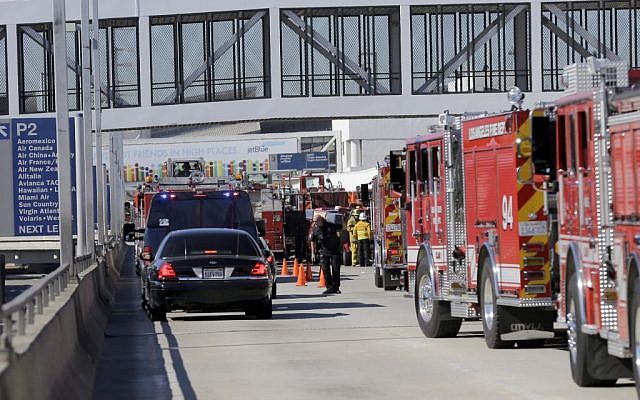 Police stand outside Los Angeles International Airport on Friday, Nov. 1, 2013. Shots were fired Friday at Los Angeles International Airport, prompting authorities to evacuate a terminal and stop flights headed for the city from taking off from other airports. (photo credit: AP/Reed Saxon) Police stand outside Los Angeles International Airport on Friday, Nov. 1, 2013. Shots were fired Friday at Los Angeles International Airport, prompting authorities to evacuate a terminal and stop flights headed for the city from taking off from other airports. (photo credit: AP/Reed Saxon)