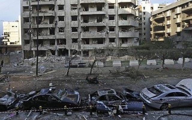 Damaged cars seen in front of a building where many Iranian diplomats live, at the scene of two explosions that struck the day before, near the Iranian embassy, in Beirut, Lebanon, Wednesday, Nov. 20, 2013 (photo credit: AP/Hussein Malla) Damaged cars seen in front of a building where many Iranian diplomats live, at the scene of two explosions that struck the day before, near the Iranian embassy, in Beirut, Lebanon, Wednesday, Nov. 20, 2013 (photo credit: AP/Hussein Malla)