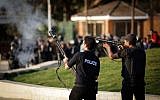Egyptian security forces fire tear gas to disperse students and supporters of the country's ousted Islamist president after they rallied outside a Cairo university, Thursday, Nov. 28, 2013 (photo credit: AP/Eman Helal)