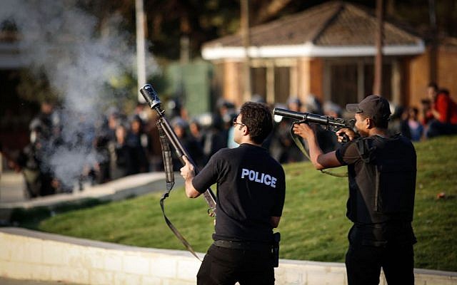 Egyptian security forces fire tear gas to disperse students and supporters of the country's ousted Islamist president after they rallied outside a Cairo university, Thursday, Nov. 28, 2013 (photo credit: AP/Eman Helal) Egyptian security forces fire tear gas to disperse students and supporters of the country's ousted Islamist president after they rallied outside a Cairo university, Thursday, Nov. 28, 2013 (photo credit: AP/Eman Helal)