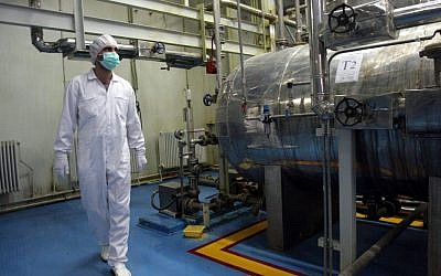 In this Feb. 2007 file photo, an Iranian technician walks through the Uranium Conversion Facility just outside the city of Isfahan, south of the capital Tehran, Iran. (photo credit: AP/Vahid Salemi)