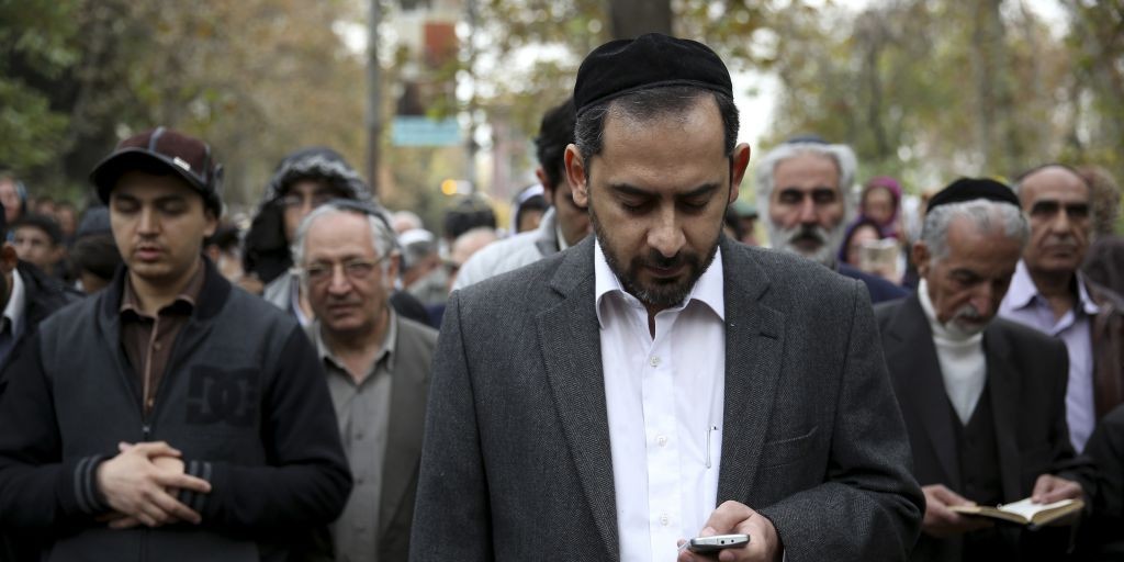 Iranian Jewish men pray in Hebrew during a gathering of Iran's Jewish community in support of their country's nuclear program in Tehran, Iran, Tuesday, November 19, 2013. (photo credit: AP/Ebrahim Noroozi) Iranian Jewish men pray in Hebrew during a gathering of Iran's Jewish community in support of their country's nuclear program in Tehran, Iran, Tuesday, November 19, 2013. (photo credit: AP/Ebrahim Noroozi)