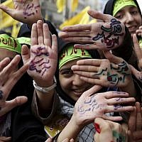 Iranian school girls raise their palms with Persian that reads 'Death to America,' during an anti-American rally in Tehran, Iran, Monday, Nov. 4, 2013 (photo credit: AP/Ebrahim Noroozi) Iranian school girls raise their palms with Persian that reads 'Death to America,' during an anti-American rally in Tehran, Iran, Monday, Nov. 4, 2013 (photo credit: AP/Ebrahim Noroozi)