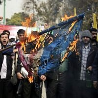 Iranian protesters burn an American flag during an annual anti-American rally in Tehran, Iran, Monday, Nov. 4, 2013 (photo credit: AP/Ebrahim Noroozi) Iranian protesters burn an American flag during an annual anti-American rally in Tehran, Iran, Monday, Nov. 4, 2013 (photo credit: AP/Ebrahim Noroozi)