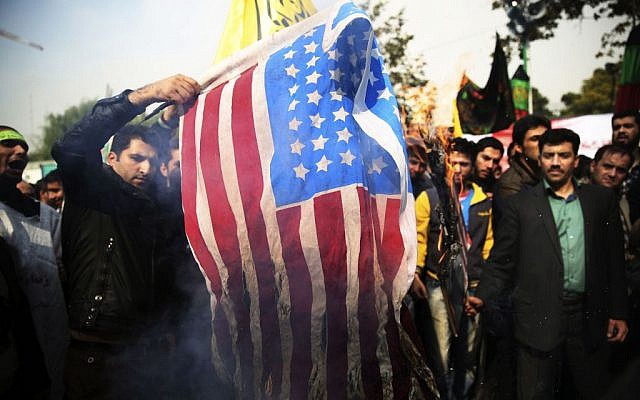 Iranian protesters burn an American flag during an anti-American rally in Tehran, Iran, Monday, Nov. 4, 2013 (photo credit: AP/Ebrahim Noroozi) Iranian protesters burn an American flag during an anti-American rally in Tehran, Iran, Monday, Nov. 4, 2013 (photo credit: AP/Ebrahim Noroozi)