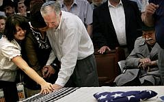 The coffin of Daniel Wultz, covered by a Jewish prayer shawl and a folded American flag, during a memorial service at a Jerusalem synagogue before transferring his body to the US for burial, on May 15, 2006. (photo credit: AP Photo/Oded Balilty)